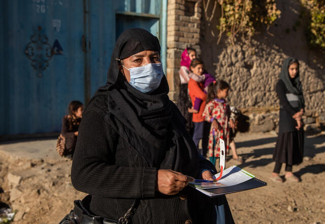 Nazo*, an IRC community health volunteer, stands outside the gate to the home where she just educated the mother living there about how to prevent malnutrition and other diseases.